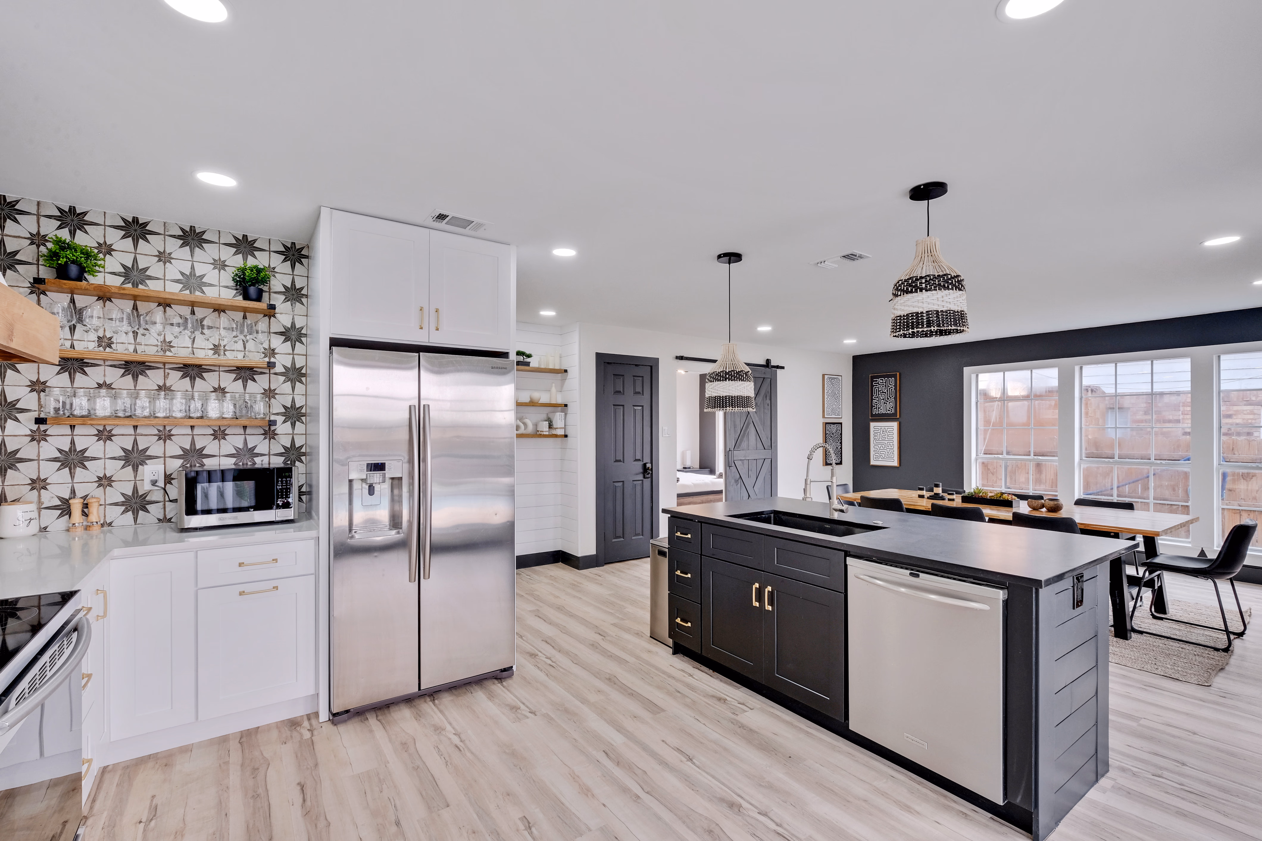 Kitchen — fridge, prep island, dining nook in background.
