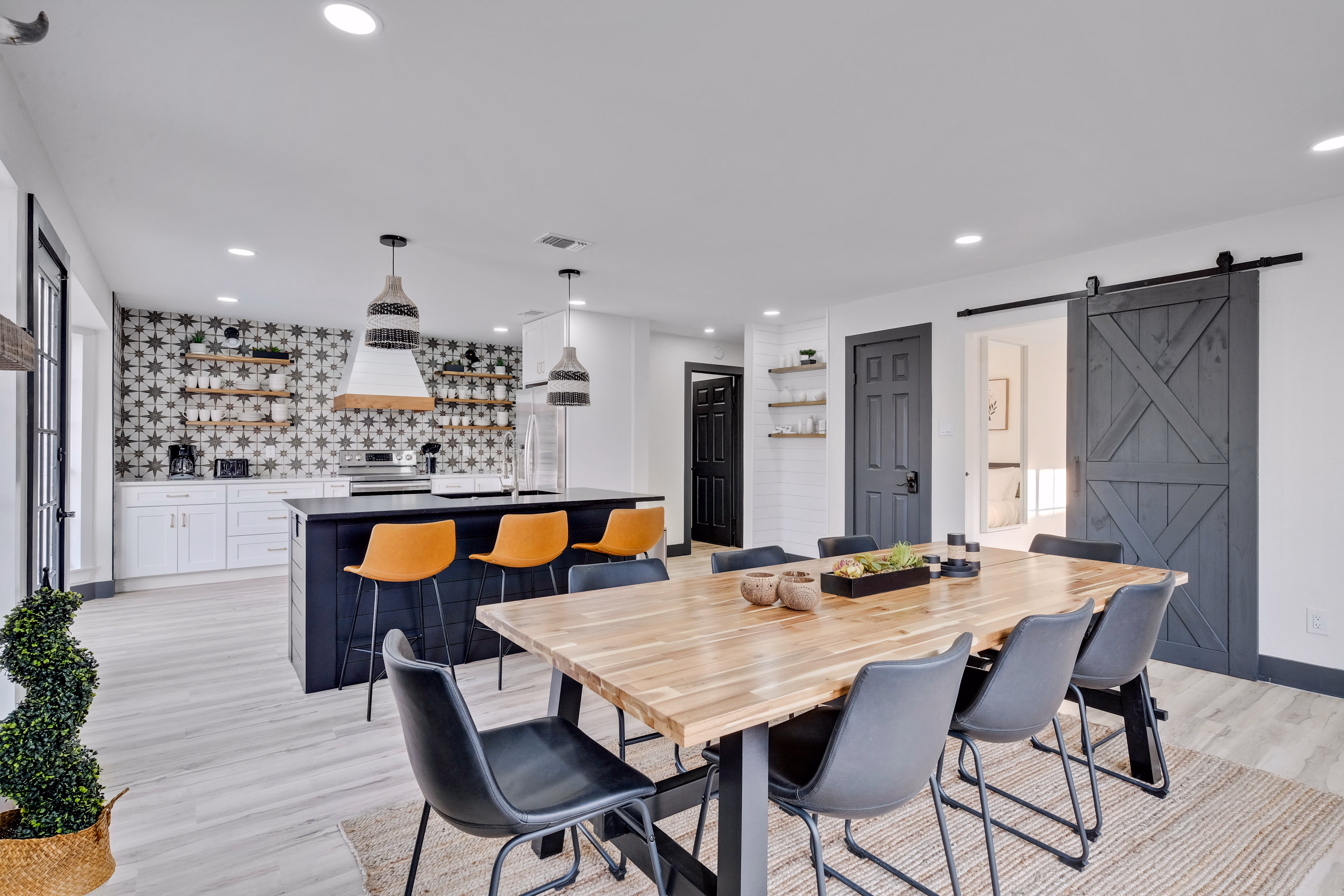 Open dining and kitchen — long wood table seats eight.