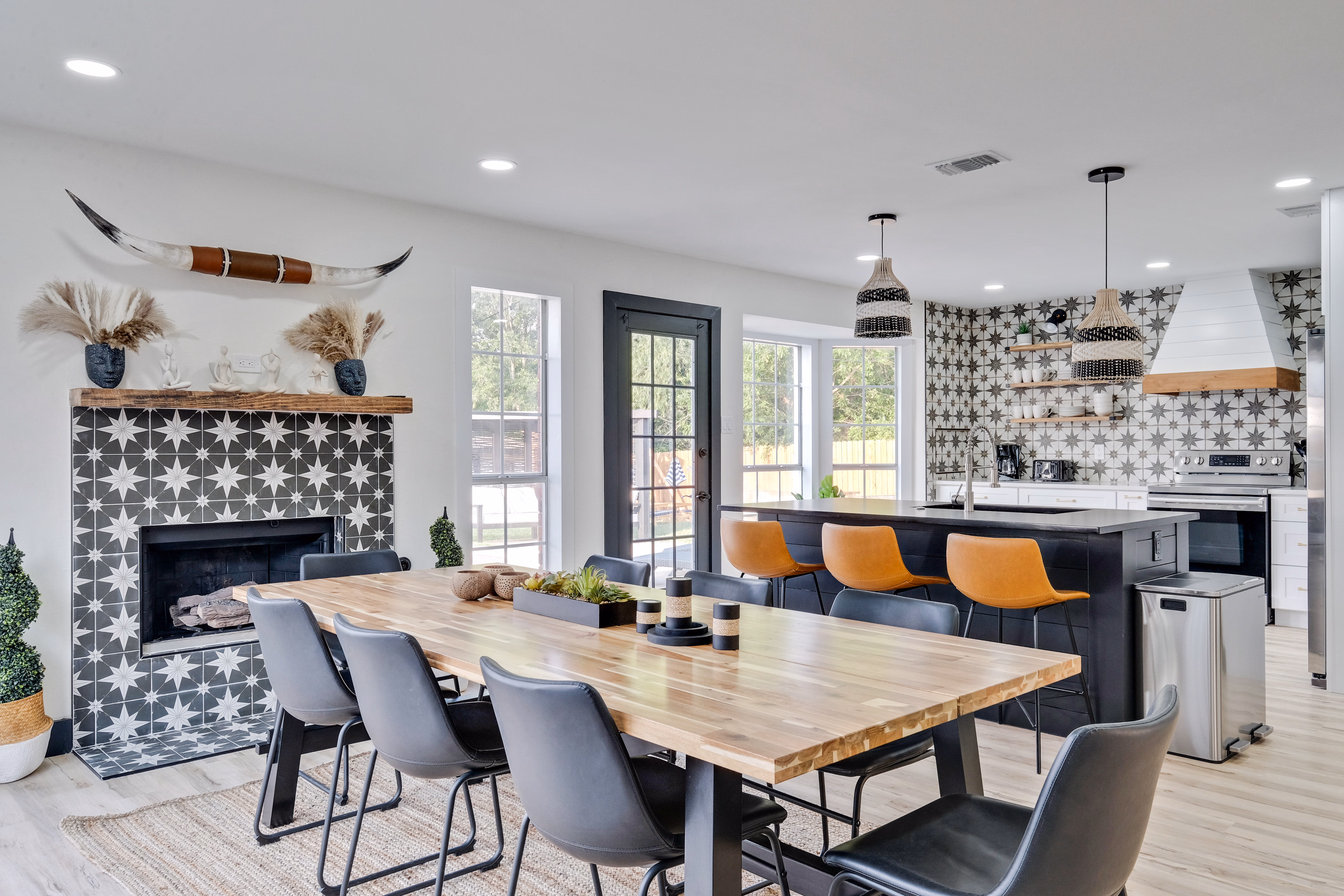 Dining room — tiled fireplace with longhorn skull, table view.