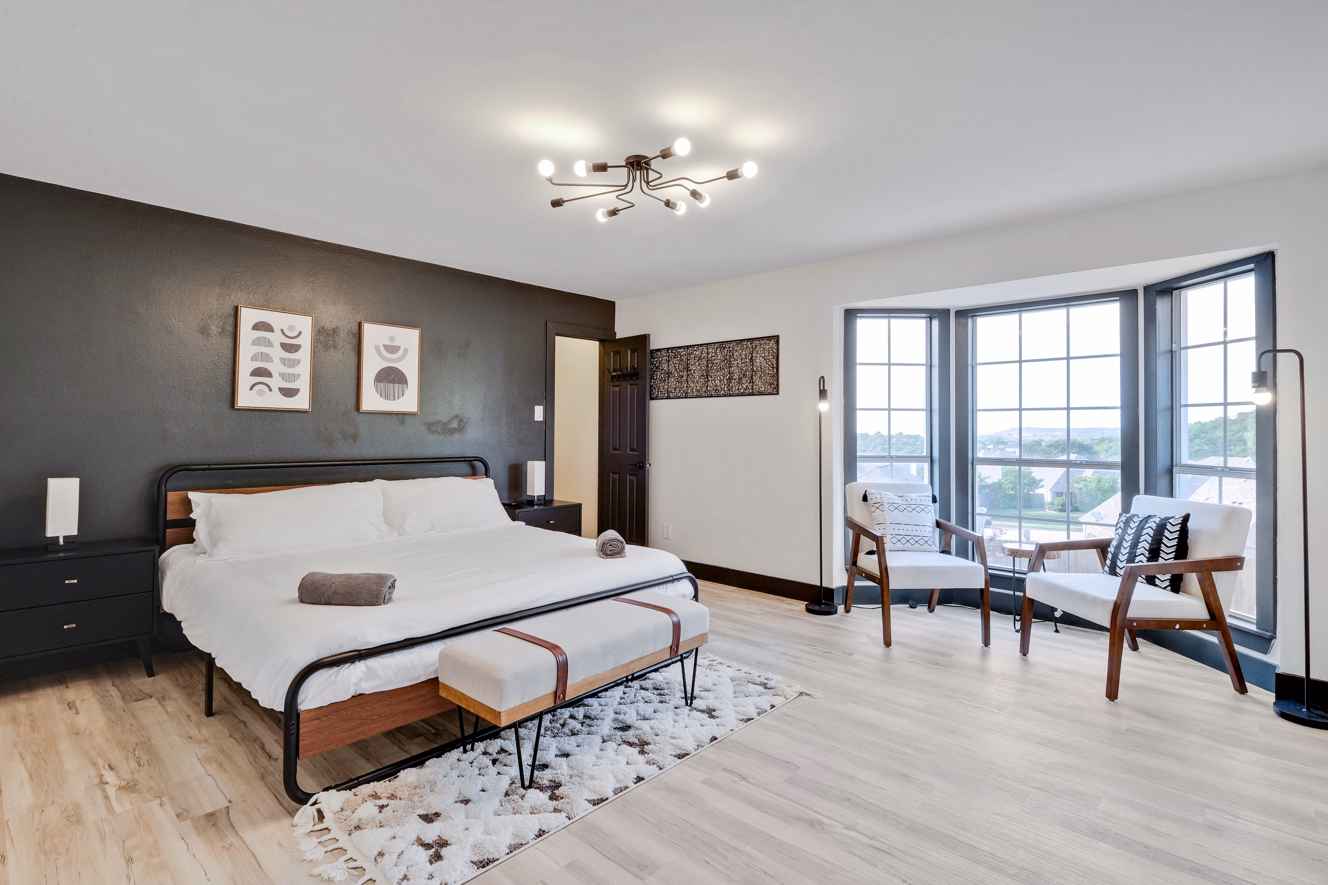 Master bedroom — king bed, bay window seating area.