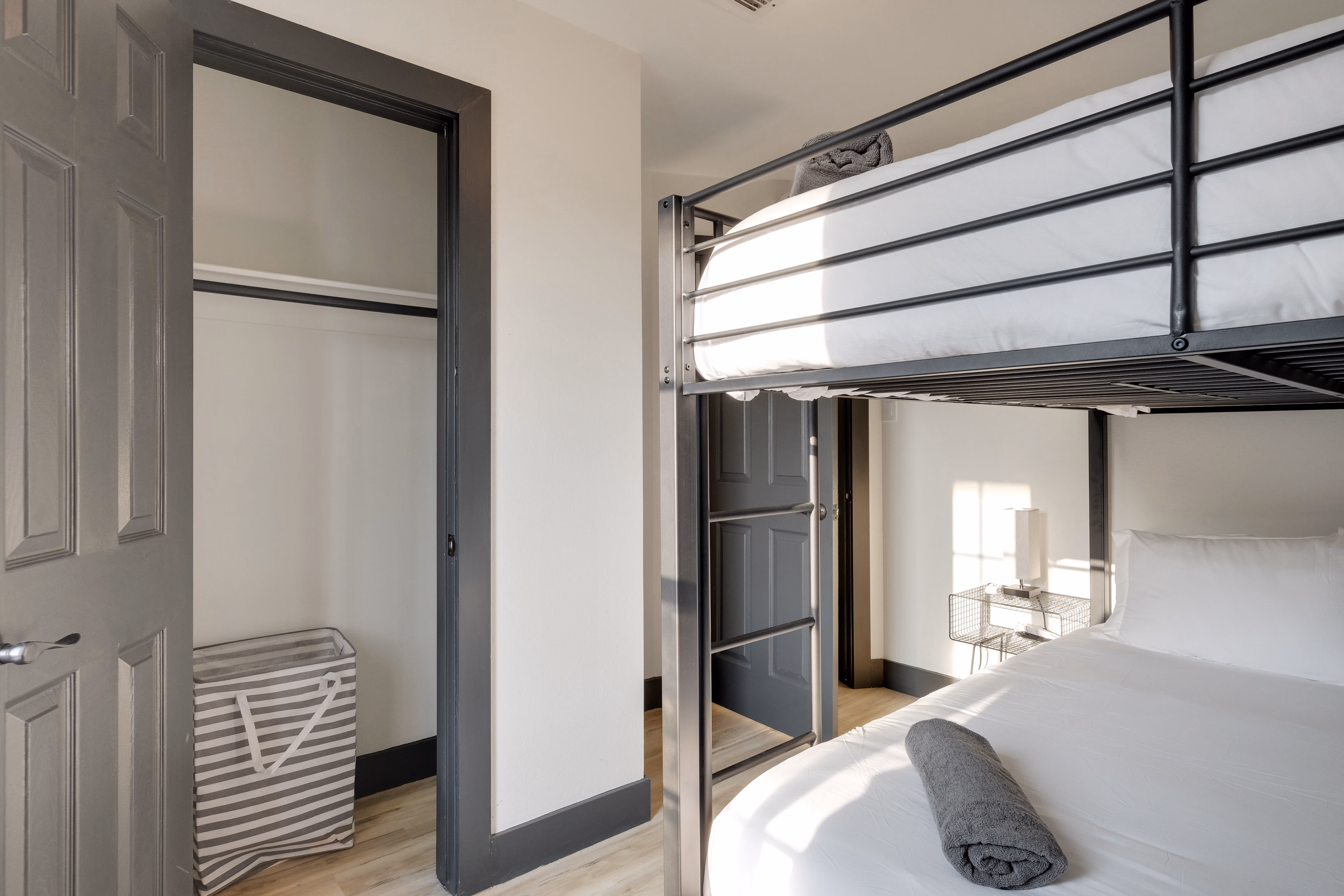 Bunk room — view of bunks with closet and hamper.