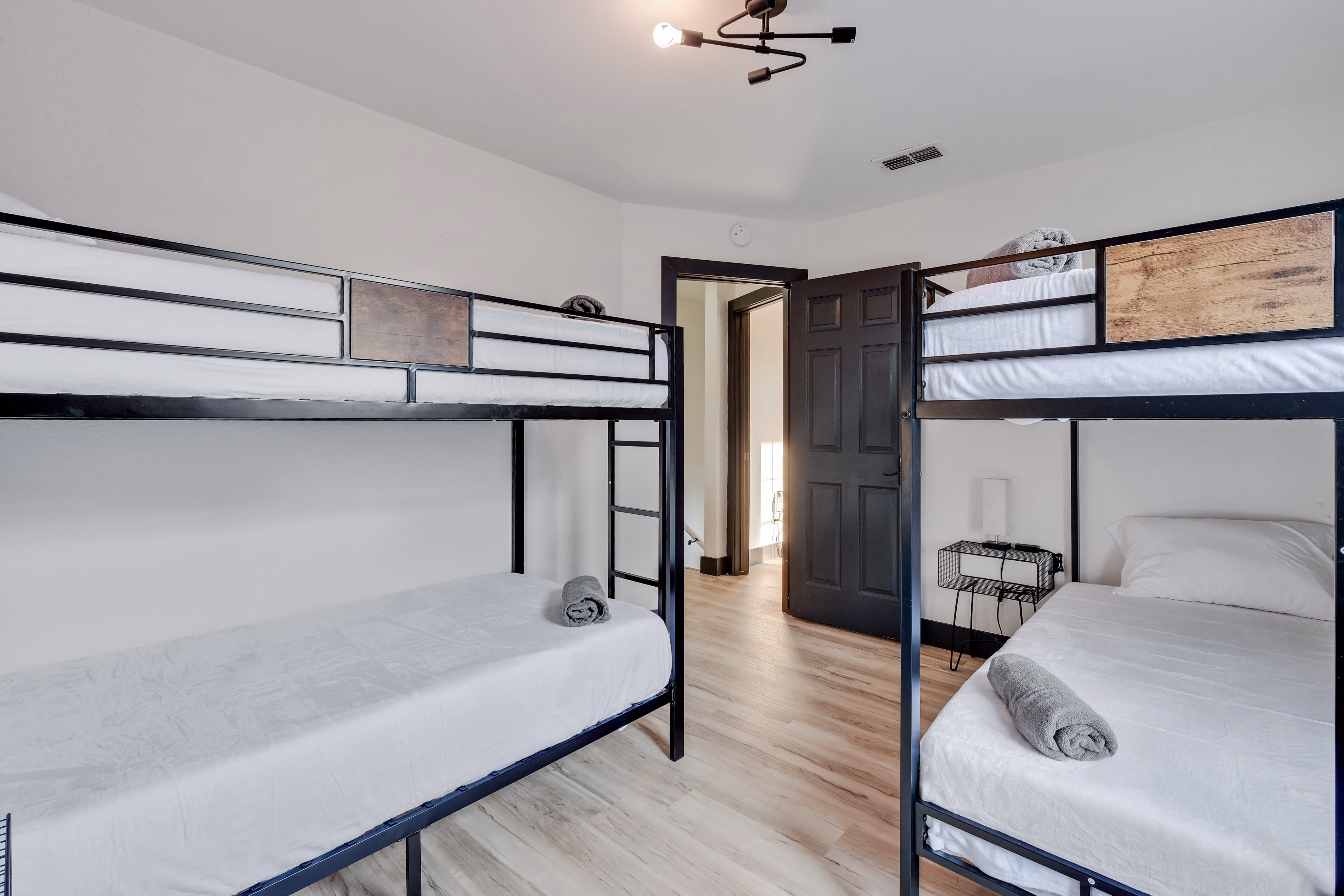 Bunk room — twin bunks with doorway between two bunk areas.
